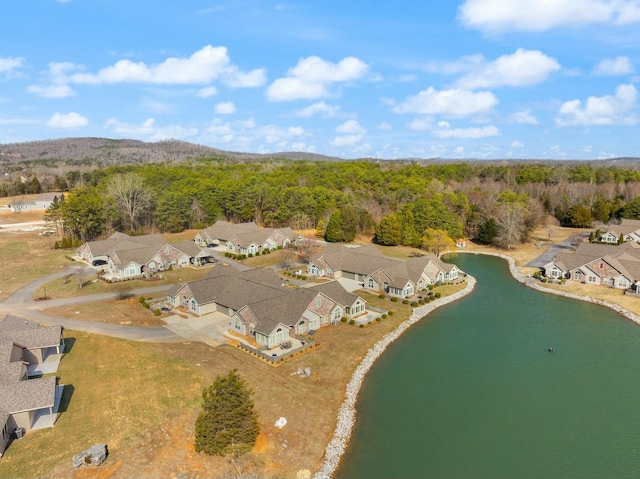 aerial view with a water view, a wooded view, and a residential view