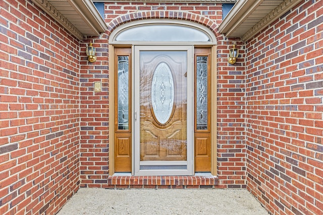 entrance to property with brick siding