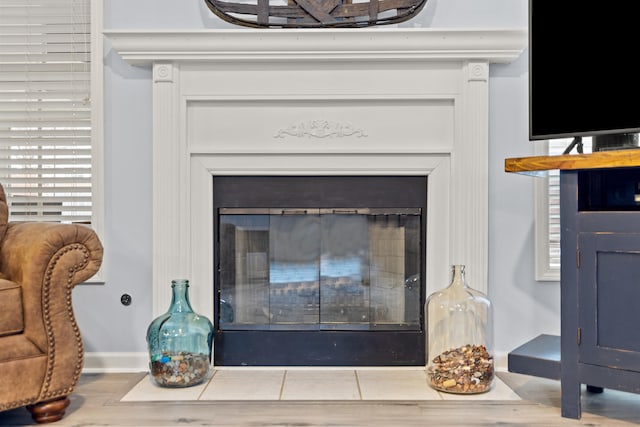 interior details featuring baseboards and a glass covered fireplace