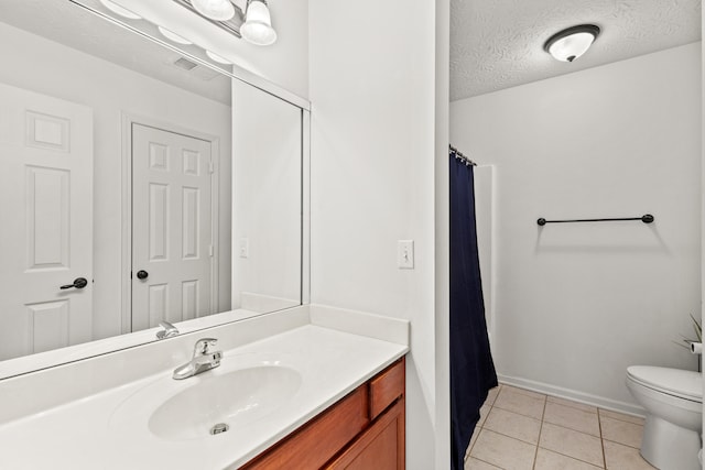 full bathroom with visible vents, toilet, vanity, a textured ceiling, and tile patterned floors