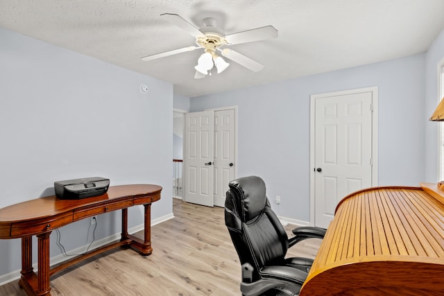 home office with ceiling fan, light wood-type flooring, and baseboards