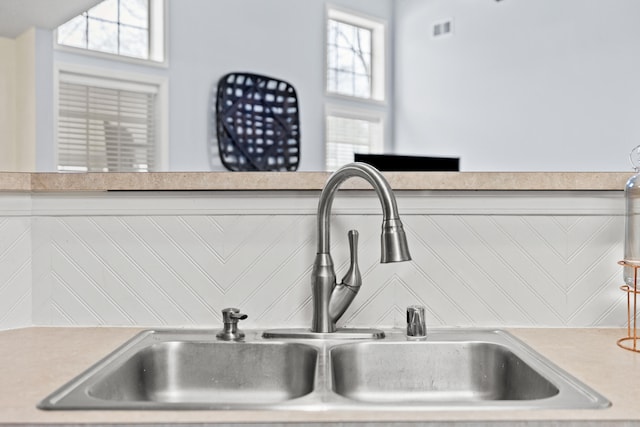 room details featuring light countertops, a sink, and visible vents