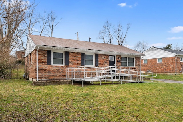 ranch-style house with fence, a front lawn, and brick siding