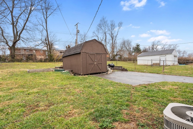 view of shed featuring cooling unit and fence