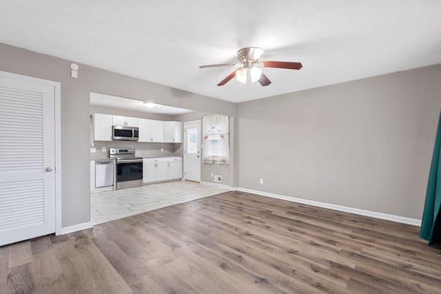 unfurnished living room featuring light wood-style flooring, baseboards, and ceiling fan