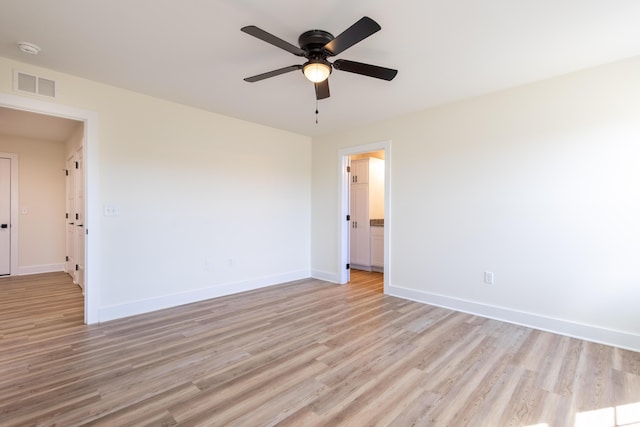 unfurnished room with a ceiling fan, visible vents, light wood-style flooring, and baseboards