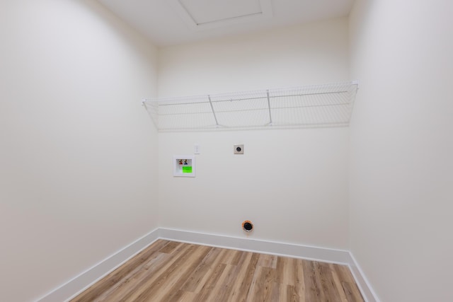 washroom featuring hookup for an electric dryer, laundry area, washer hookup, baseboards, and light wood-type flooring