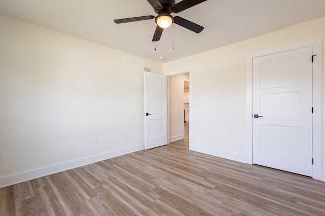 unfurnished bedroom with light wood-type flooring, visible vents, and baseboards