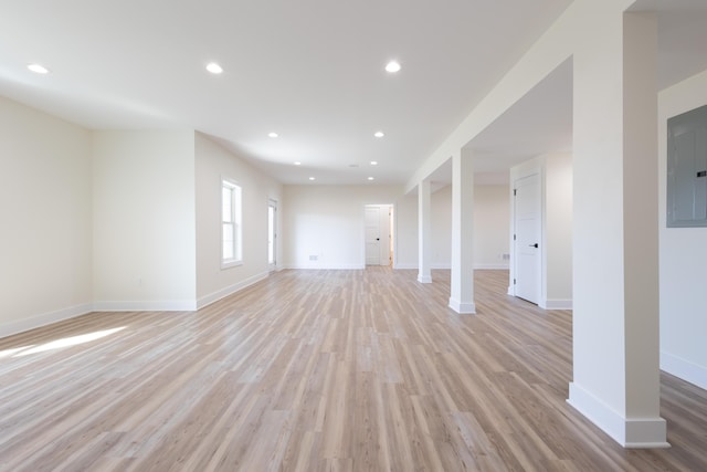 unfurnished living room with light wood-style floors, electric panel, and recessed lighting