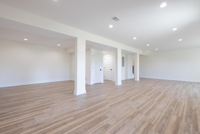 finished basement featuring light wood-style floors, baseboards, and recessed lighting