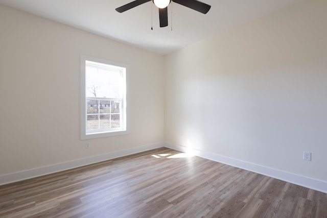 unfurnished room with ceiling fan, baseboards, and wood finished floors