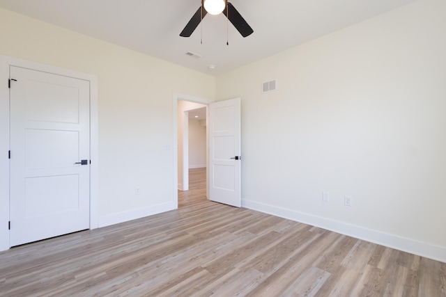 unfurnished bedroom with light wood-style flooring, visible vents, baseboards, and a ceiling fan