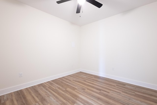 unfurnished room featuring ceiling fan, light wood finished floors, and baseboards