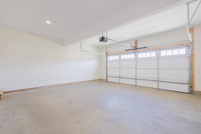 garage featuring a garage door opener, recessed lighting, and baseboards