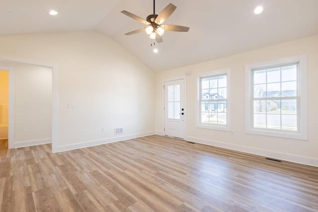 interior space with lofted ceiling, light wood-style floors, baseboards, and visible vents