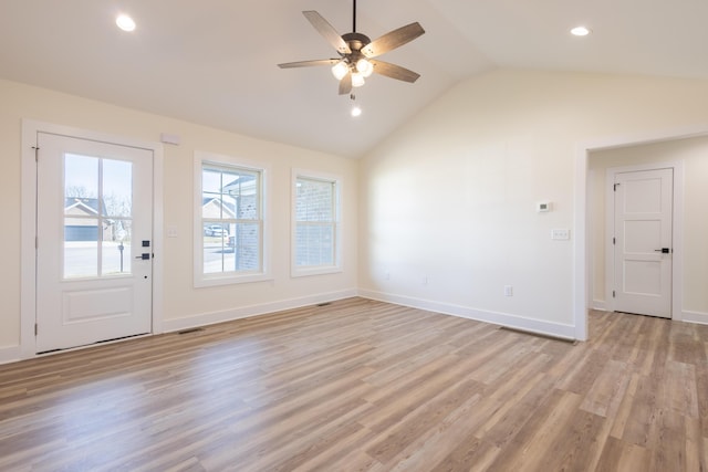 interior space with light wood finished floors, recessed lighting, visible vents, vaulted ceiling, and baseboards