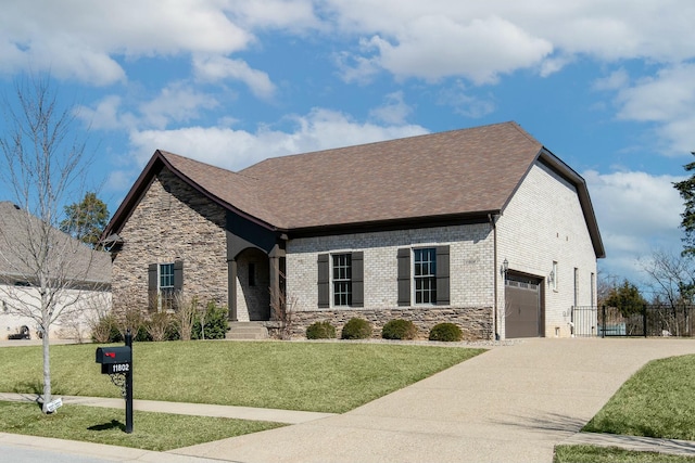 view of front facade featuring a front lawn, brick siding, stone siding, and driveway