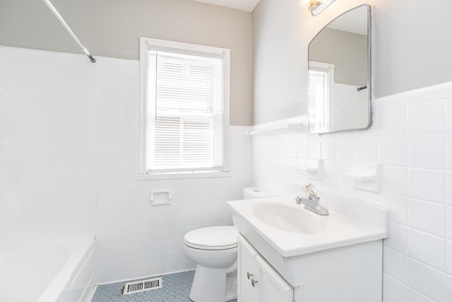 full bathroom with visible vents, a wainscoted wall, toilet, tile walls, and vanity