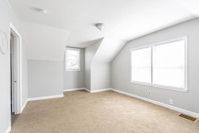 bonus room with visible vents, carpet flooring, lofted ceiling, and baseboards