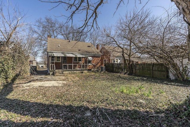 exterior space featuring central AC unit, a chimney, and fence