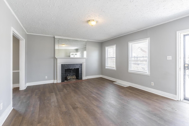 unfurnished living room featuring visible vents, a fireplace, wood finished floors, and ornamental molding