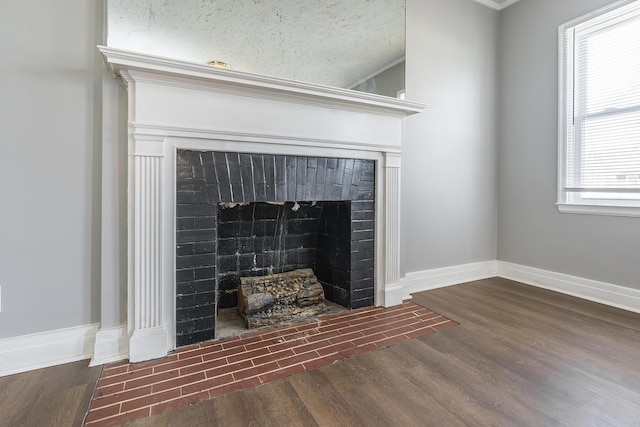 details with a fireplace, baseboards, and wood finished floors