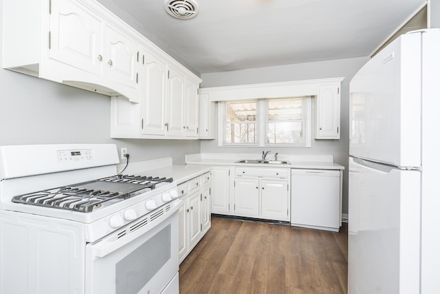 kitchen with a sink, visible vents, white appliances, and white cabinetry