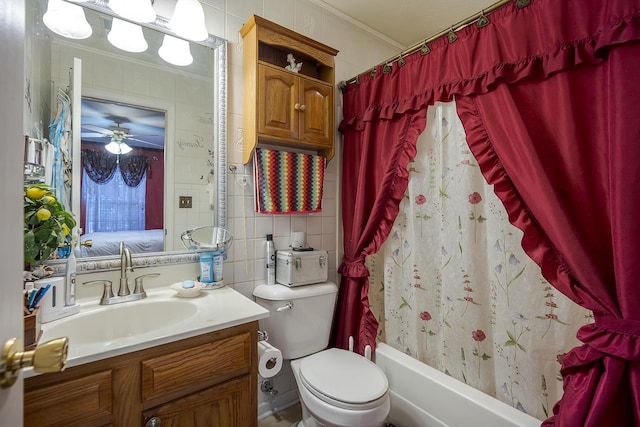 ensuite bathroom featuring toilet, ornamental molding, tile walls, shower / tub combo, and vanity