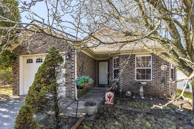 single story home with brick siding and a garage