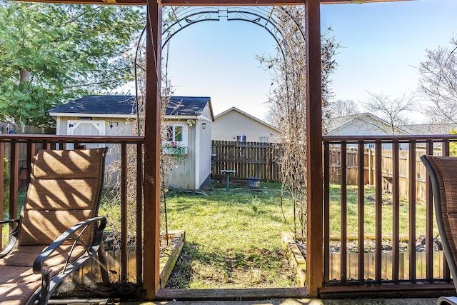 view of yard featuring a storage unit, an outdoor structure, and a fenced backyard