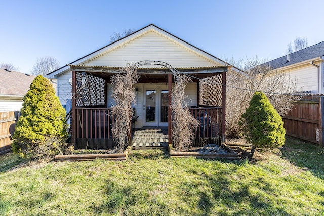 back of house featuring a yard and fence