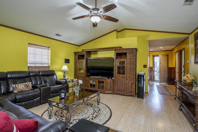 living area featuring visible vents, ornamental molding, wood finished floors, lofted ceiling, and ceiling fan