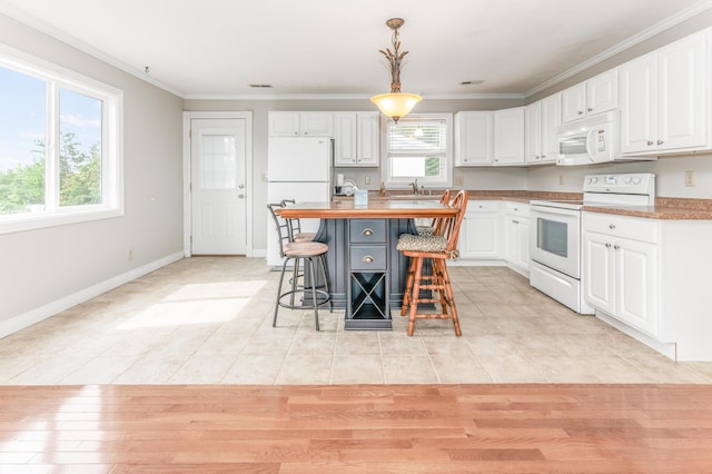 1276 Garland Rd, Burnside, KY 42519 - kitchen with white appliances, white cabinetry, a breakfast bar, light tile patterned floors, and pendant lighting