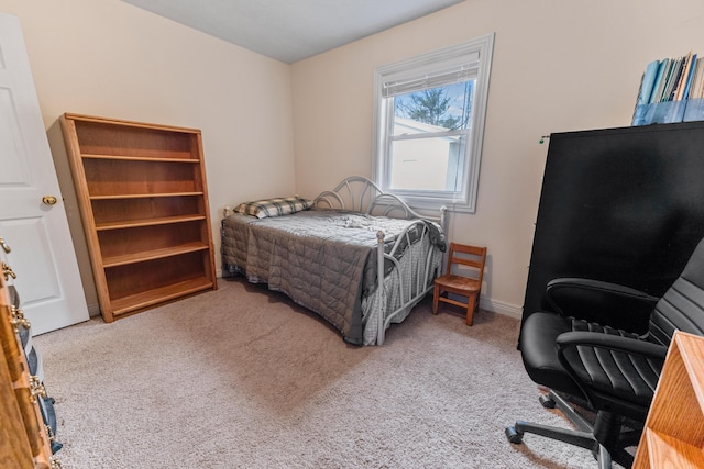 bedroom with carpet floors and baseboards