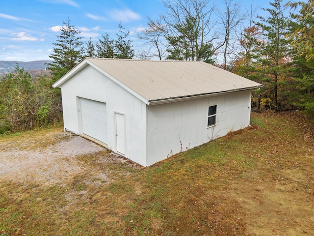 detached garage with gravel driveway