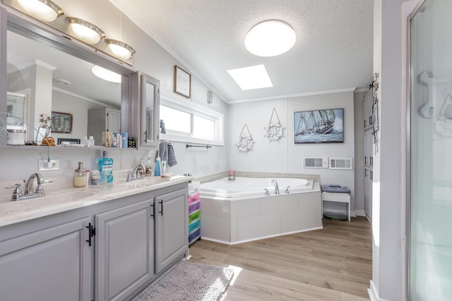 bathroom featuring crown molding, a sink, and a textured ceiling