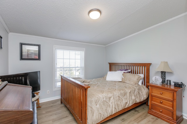 bedroom with light wood-style floors, crown molding, a textured ceiling, and baseboards