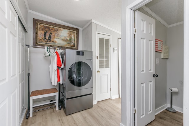 washroom with laundry area, light wood-style flooring, washer / clothes dryer, and crown molding