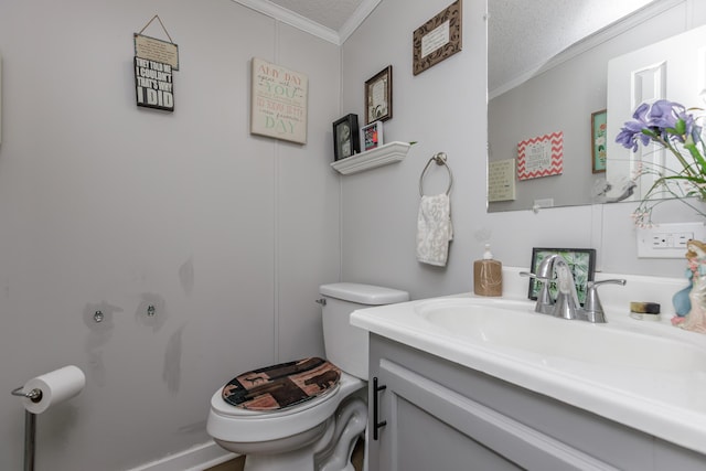 bathroom featuring ornamental molding, vanity, toilet, and a textured ceiling