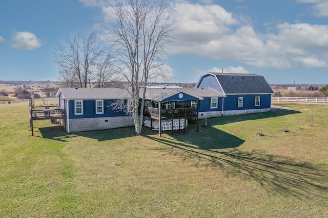 view of front of property with crawl space, a deck, fence, and a front lawn