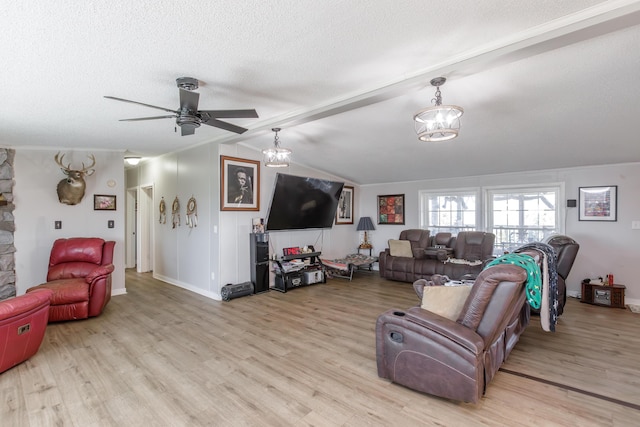 living room with a textured ceiling, lofted ceiling with beams, ceiling fan with notable chandelier, wood finished floors, and baseboards