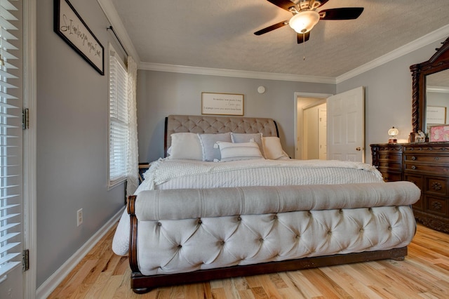 bedroom featuring crown molding, a textured ceiling, baseboards, and light wood-style floors