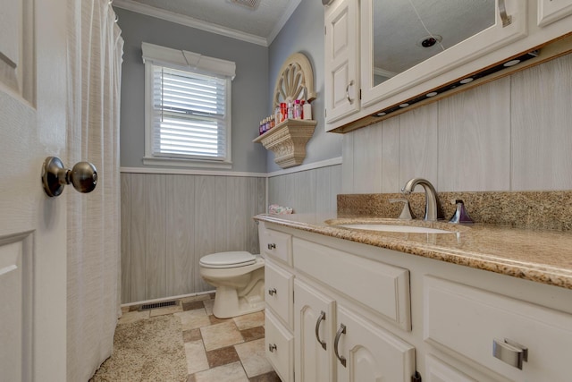 bathroom featuring crown molding, visible vents, toilet, wainscoting, and vanity