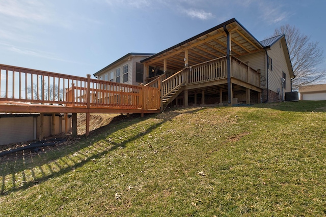 rear view of property with metal roof, cooling unit, a deck, and a lawn