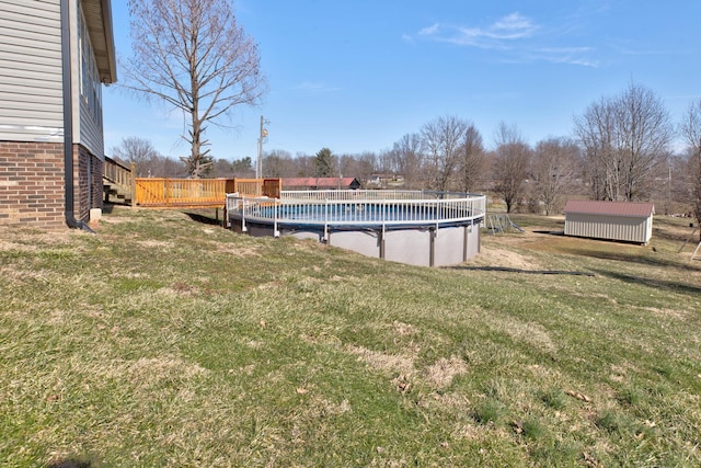 view of yard featuring a covered pool and a wooden deck