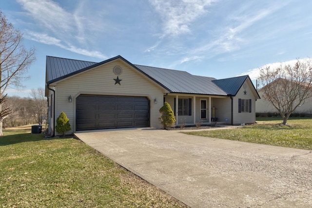 single story home with metal roof, central AC unit, an attached garage, driveway, and a front lawn