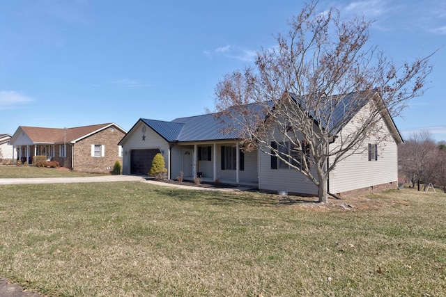 ranch-style house featuring a garage, metal roof, concrete driveway, and a front yard