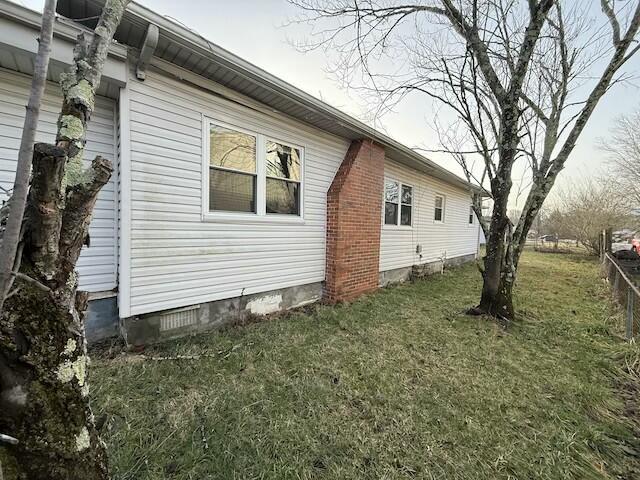 view of home's exterior featuring crawl space and a yard