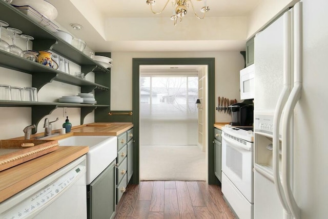 kitchen featuring dark wood-style floors, open shelves, wooden counters, white appliances, and green cabinetry