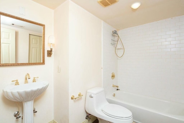 bathroom with visible vents, a sink, toilet, and shower / bathtub combination